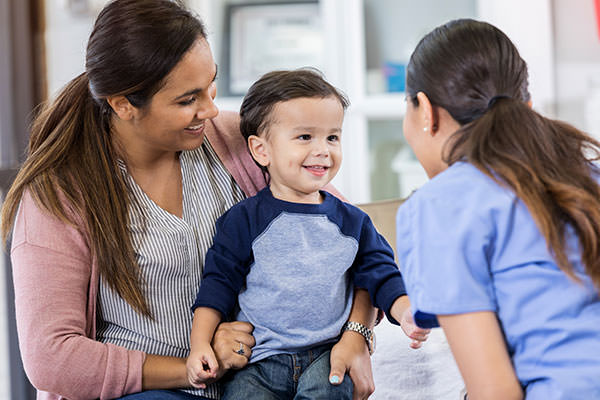 Female physician with mother and child